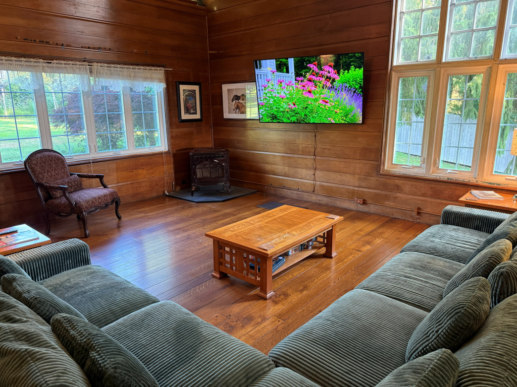Pine Suite with Private Bathroom | Room 2 Storm King Lodge Living Room with 75 in TV and Pettet Stove